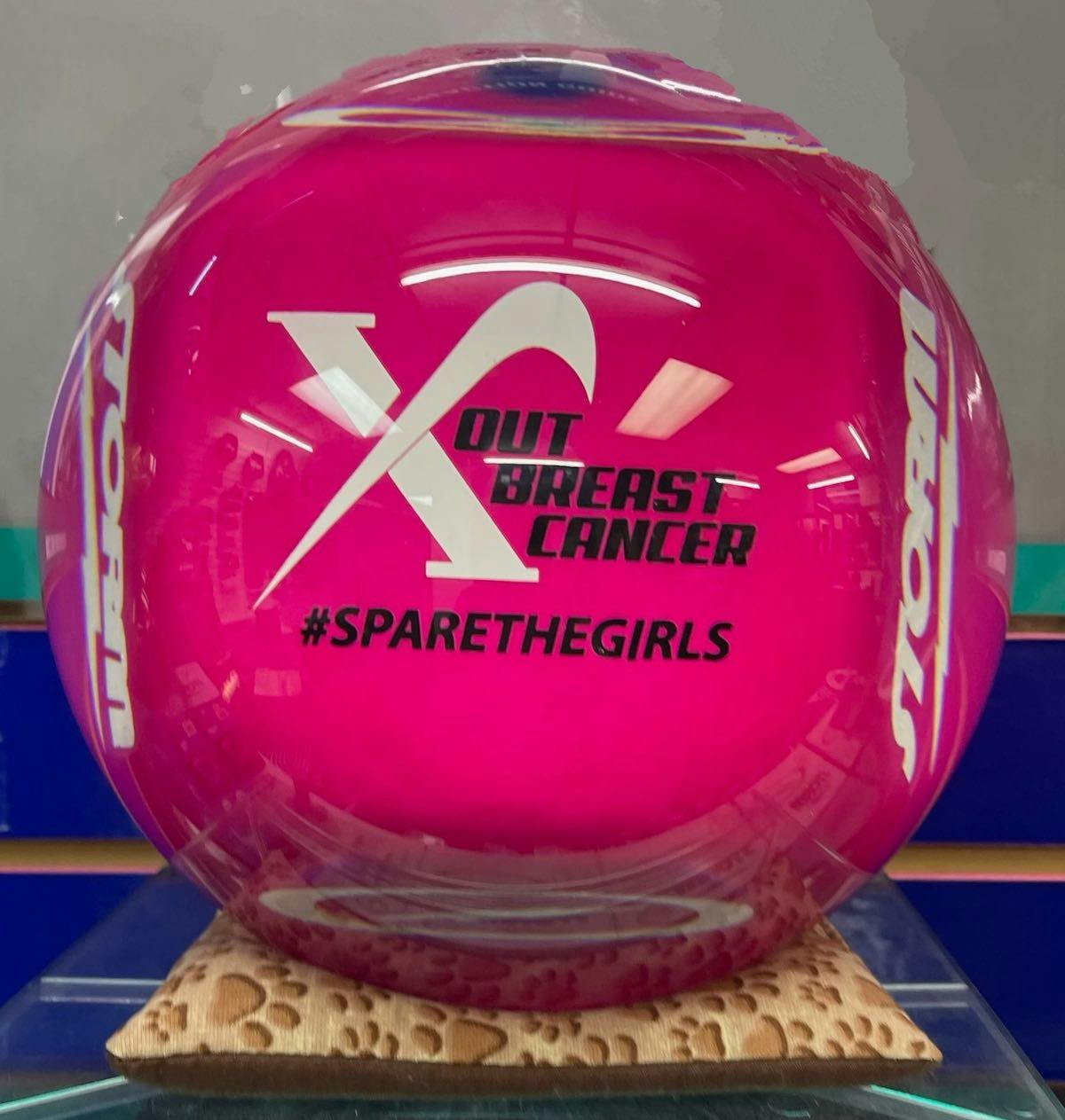 The raffle prize is a bowling ball with the charity logo